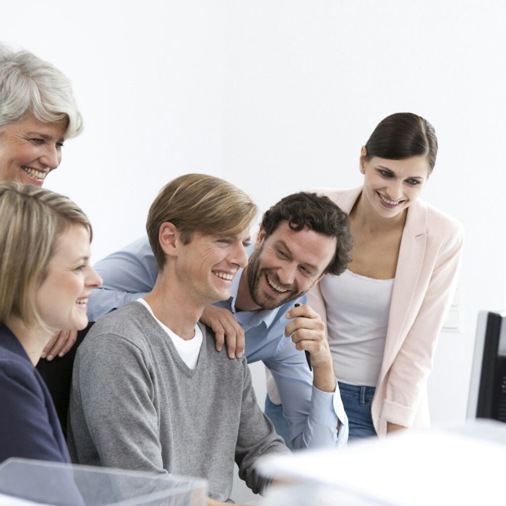 Happy business team at desk in office